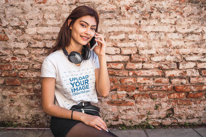 T-Shirt Mockup Featuring a Young Woman Talking on the Phone