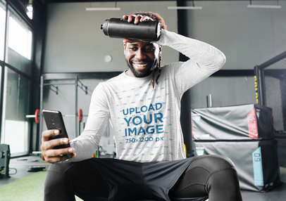Long Sleeve Tee Mockup of a Man Checking His Phone at the Gym 