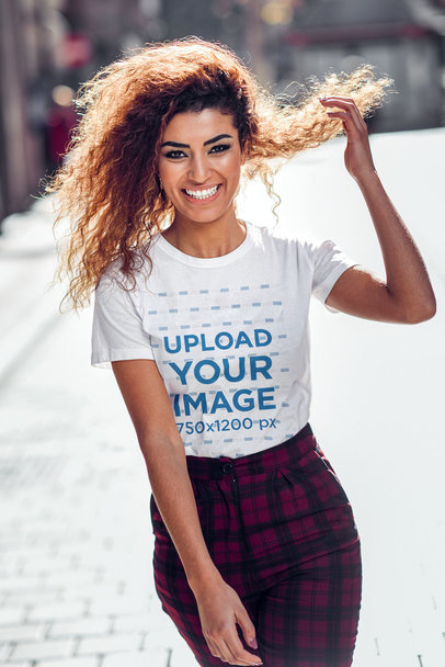 Round-Neck Tee Mockup of a Woman with Long Hair Walking on the Street