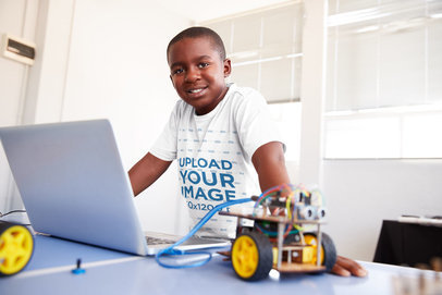Tee Mockup of a Smiling Boy at a Robotics Classroom