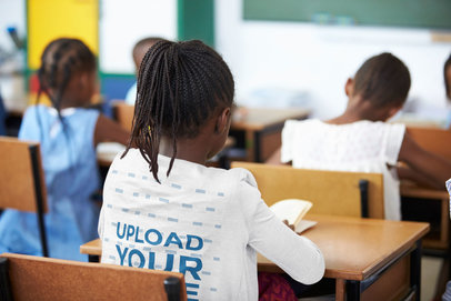 Back-View Mockup of a Girl with a Long Sleeve Tee at a Classroom