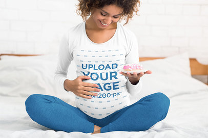 Long Sleeve Tee Mockup Featuring a Joyful Pregnant Woman Sitting on Her Bed 