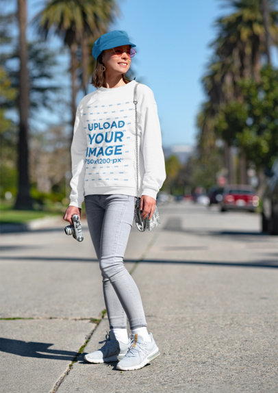 Mockup of a Young Woman with a Sweatshirt and a Vintage Camera