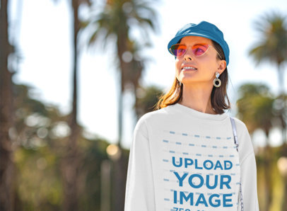 Crewneck Sweatshirt Mockup of a Young Woman with Sunglasses Posing on the Street