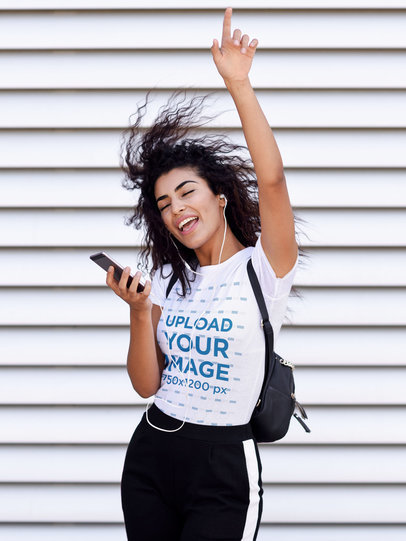 T-Shirt Mockup of a Young Woman Happily Listening to Music 