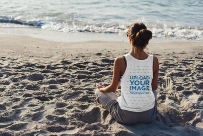 Back View Mockup of a Woman with a Tank Top Meditating on the Beach