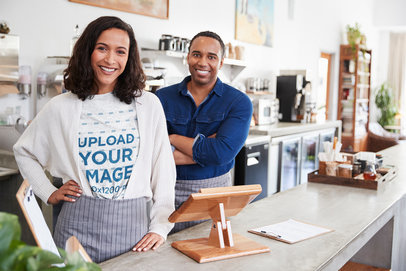 Heather T-Shirt Mockup of a Barista Posing Behind a Store's Counter 