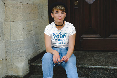 Sublimated T-Shirt Mockup of a Short-Haired Woman Sitting on a Granite Stair 