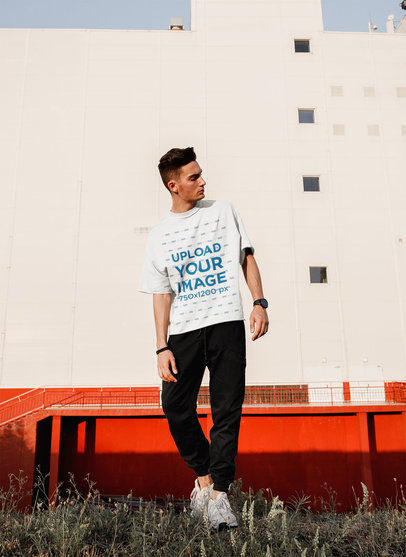 Mockup of a Man with a Half-Sleeve T-Shirt Standing on the Street