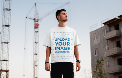 T-Shirt Mockup of a Man with a Casual Look Standing on the Street 