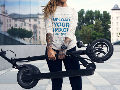Long Sleeve Tee Mockup of a Woman Holding a Foldable Scooter