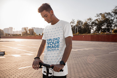Mockup of a Man with a Long T-Shirt Riding a Scooter