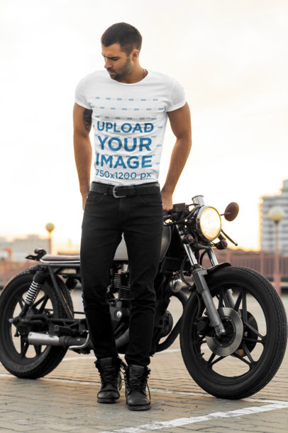 T-Shirt Mockup of a Stylish Man Posing in front of His Motorcycle