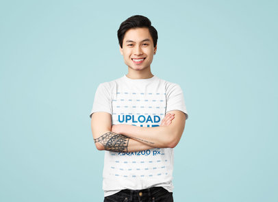 T-Shirt Mockup of a Smiling Tattooed Man in a Studio