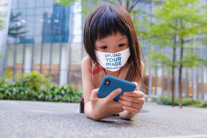 Face Mask Mockup of a Girl Lying on the Street