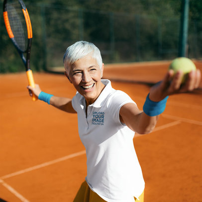 Polo Shirt Mockup Featuring a Senior Woman Playing Tennis