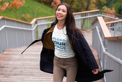 T-Shirt Mockup of a Happy Woman Posing on an Autumn Day 