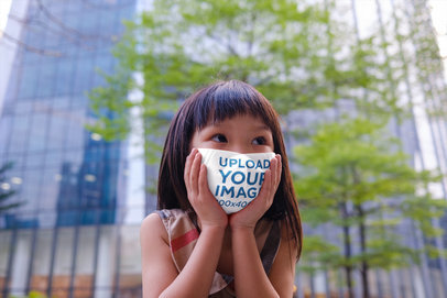Mockup of a Girl Touching Her Face Mask