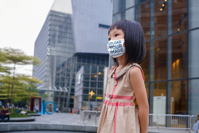 Mockup of a Little Girl Wearing a Face Mask in the City