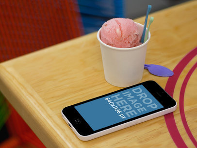 iPhone 5C Mockup Featuring an Ice Cream over a Table