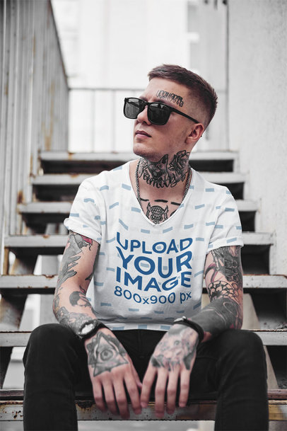 Mockup of a Man with a Sublimated V-Neck Tee Sitting on the Stairs 35245-r-el2