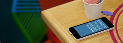Wide Mockup Featuring an iPhone 5C Next to an Ice Cream
