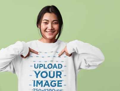 Studio Mockup of a Woman Pointing at Her Sweatshirt