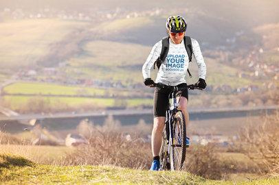 Long-Sleeve Tee Mockup of a Man Biking at the Mountains