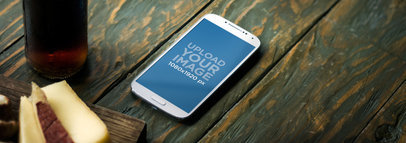 Mockup of a Samsung Galaxy in Portrait Position Placed on a Wooden Table