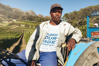 Mockup of a Farmer with a T-Shirt Sitting on a Tractor 38989-r-el2