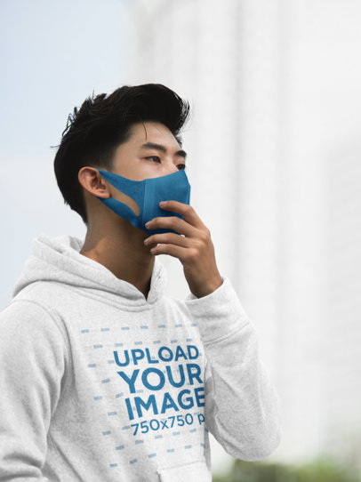 Hoodie Mockup of a Young Man Wearing a Face Mask