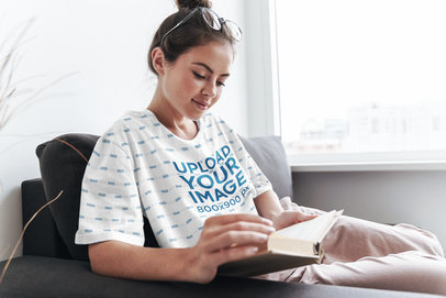 Sublimated T-Shirt Mockup of a Woman Reading at Home