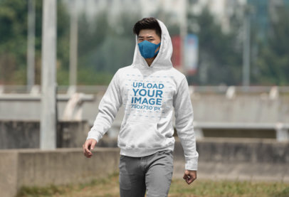 Mockup of a Man Walking on a Street with a Pullover Hoodie