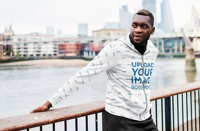 Sublimated Hoodie Mockup of a Man Posing by a River