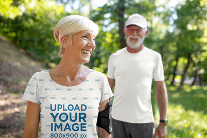 Mockup Featuring a Senior Woman Wearing a Sublimated Tee at the Mountains