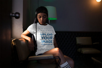 T-Shirt Mockup Featuring a Woman in a Low Lit Room 17204