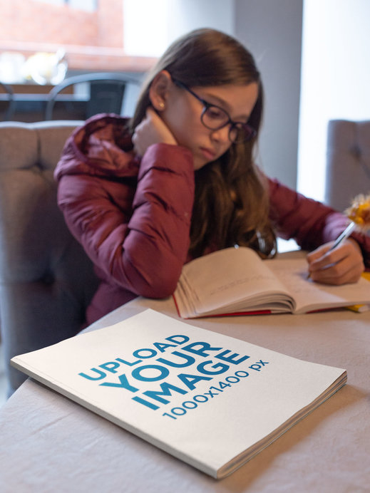 Book Mockup of a Young Girl Studying at Home