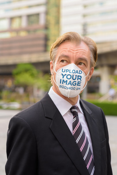 Face Mask Mockup Featuring a Middle-Aged Businessman 
