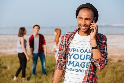 Round-Neck Tee Mockup Featuring a Smiling Man Talking on His Mobile