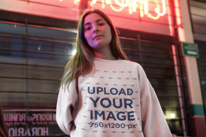 Sweatshirt Mockup of a Young Woman Posing on the Street