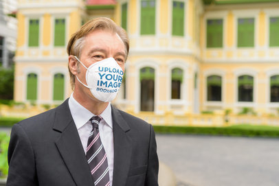 Mockup of a Businessman Wearing a Face Mask