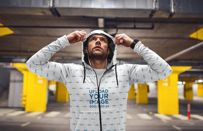 Mockup of a Man Exercising in a Parking Lot with a Sublimated Heather Hoodie 40058-r-el2