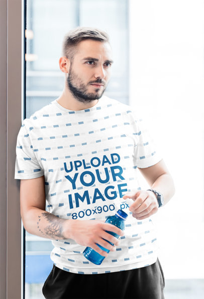 Mockup of a Tattooed Man Wearing a Sublimated T-Shirt 