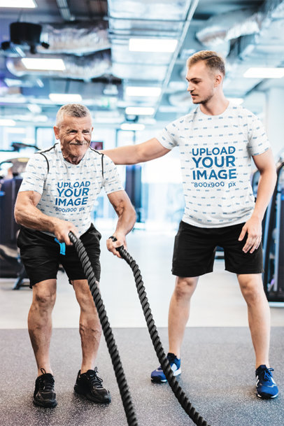 Sublimated Tee Mockup of a Coach Training an Elderly Man at a Gym
