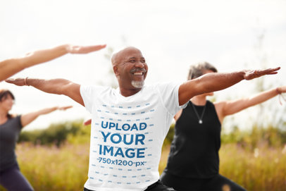 T-Shirt Mockup of a Senior Man Doing Yoga Outdoors