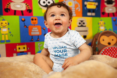Mockup of a Joyful Baby Boy Smiling Wearing A Onesie