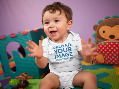 Happy White Baby Boy Clapping While Sitting Down Wearing A Onesie Mockup