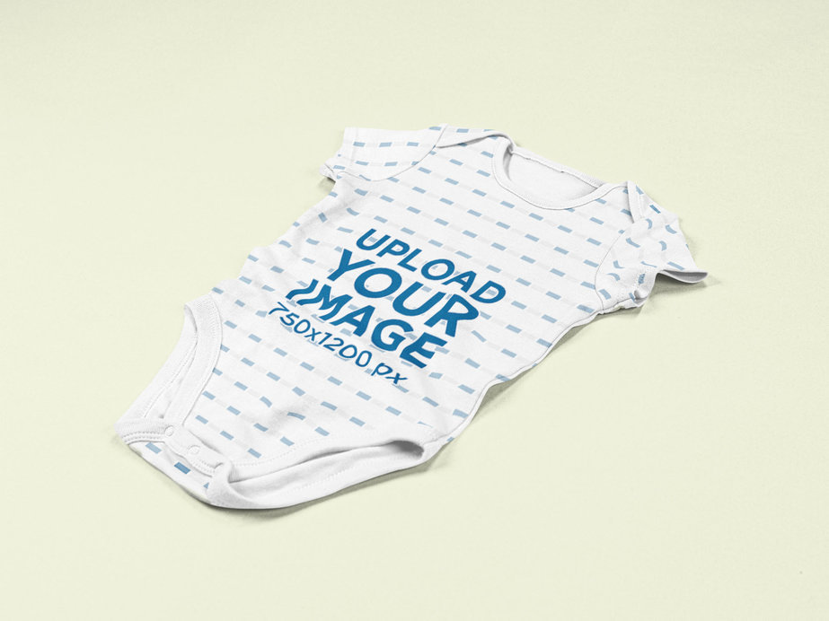 Mockup of a Sublimated Onesie on a Customizable Color Surface