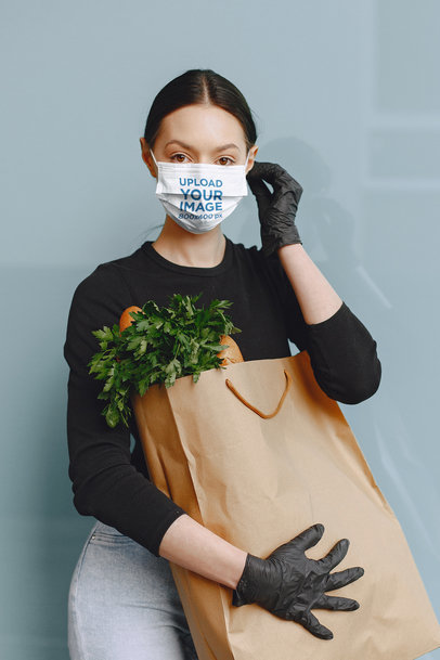 Face Mask Mockup of a Woman Carrying a Bag of Groceries