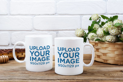 Mockup of Two Customizable 11 oz Mugs Placed Next to a Flower Basket